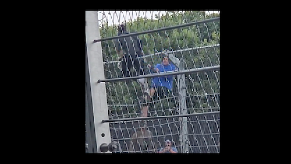 Watch Pro Hamas Protestor Tries to Display Anti Israel Signs During NASCAR Race in Chicago Man Scales Fence to Rip Them to Shreds Video